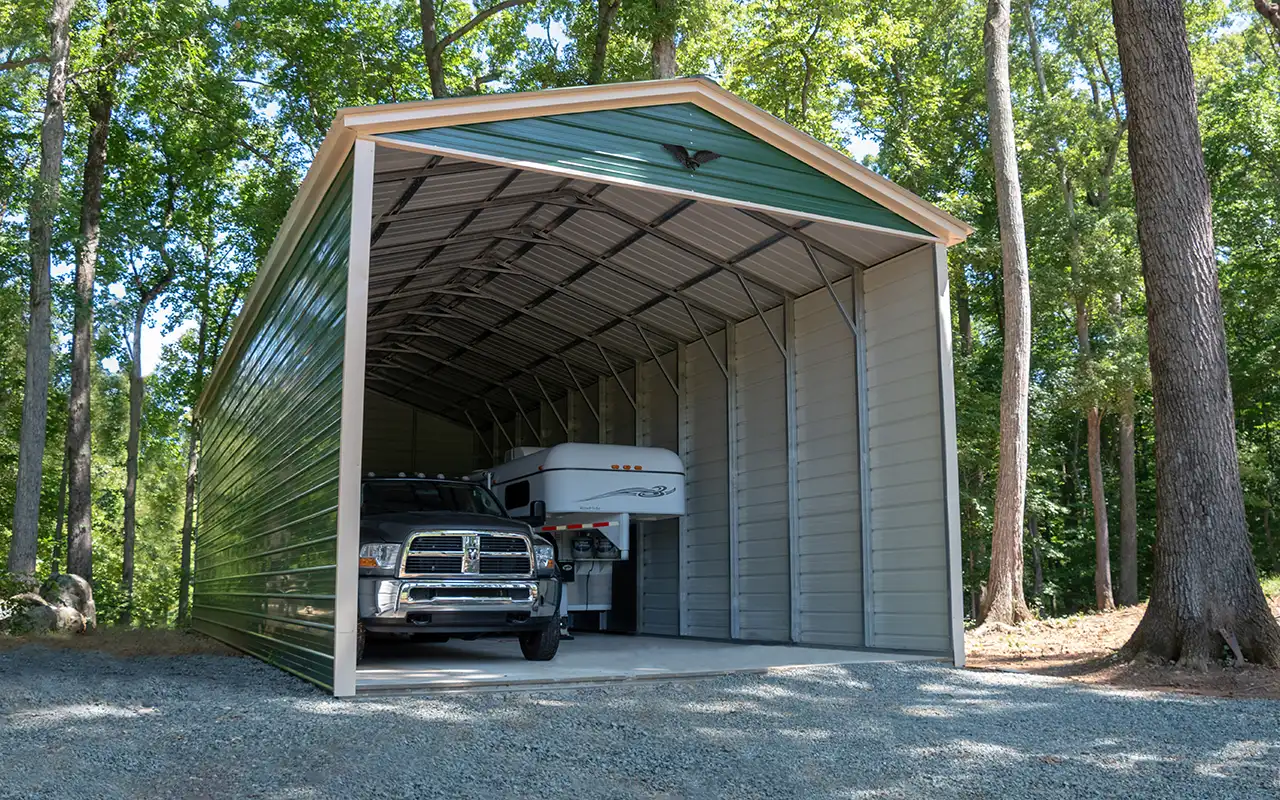 Photo of a green metal carport kit with a truck and an RV parked inside.